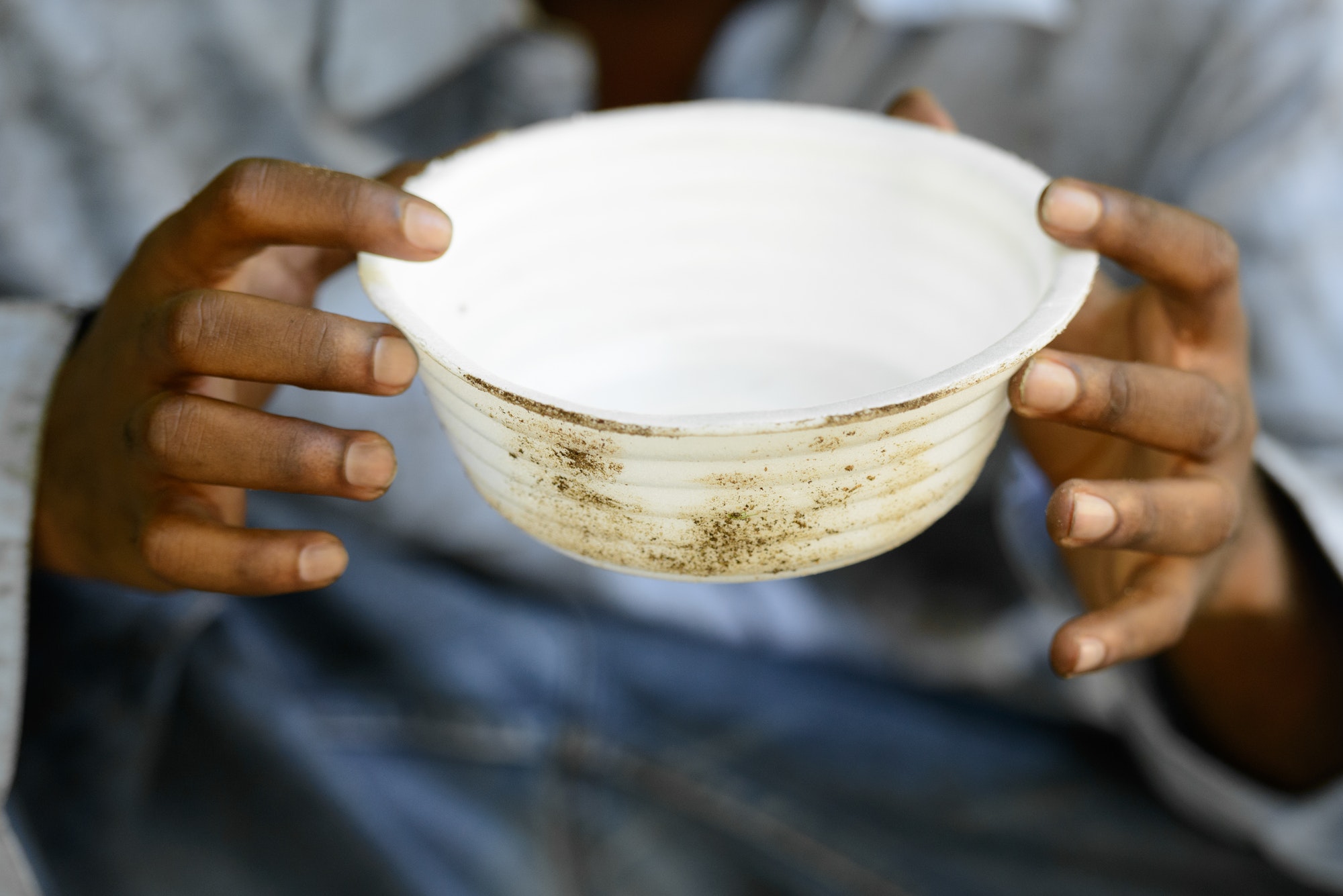 hands of young homeless african man begging for food